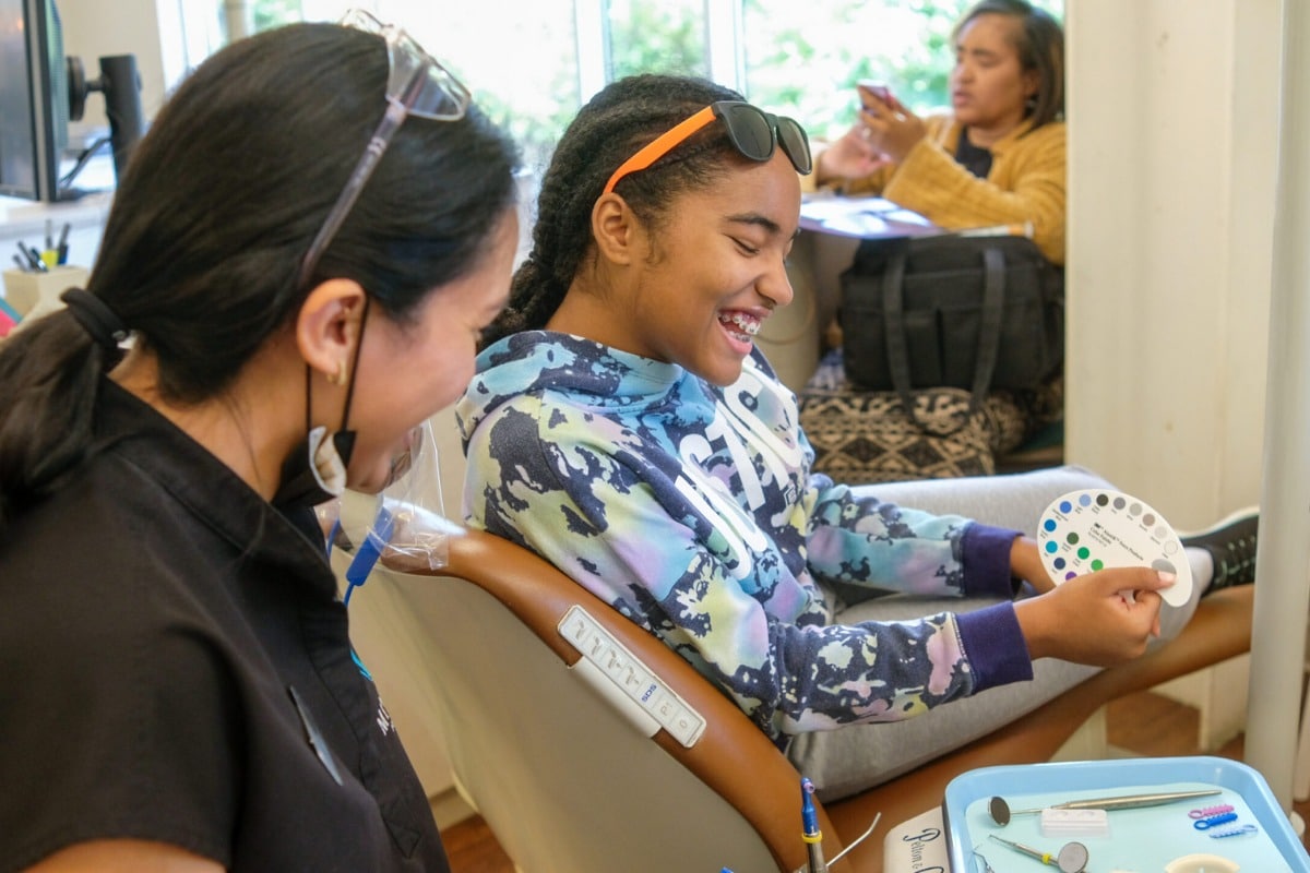 Teen patient choosing orthodontic band colors during a braces appointment at minera orthodontics in warrenton, va.