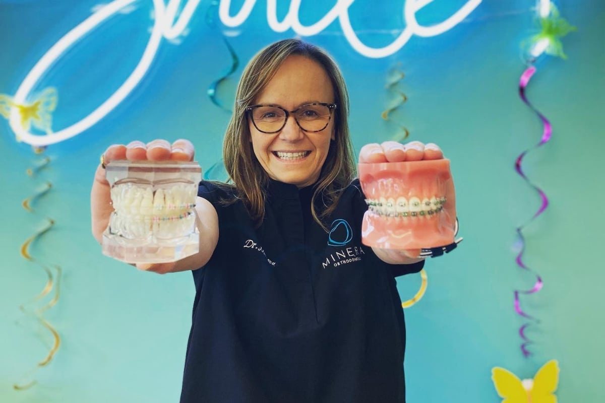 Dr. Minera holding orthodontic models demonstrating braces treatment at minera orthodontics in warrenton, va.