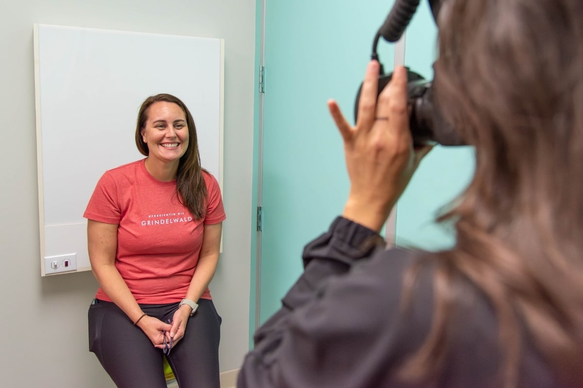 Smiling woman having her photo taken in an orthodontic office for a smile transformation.